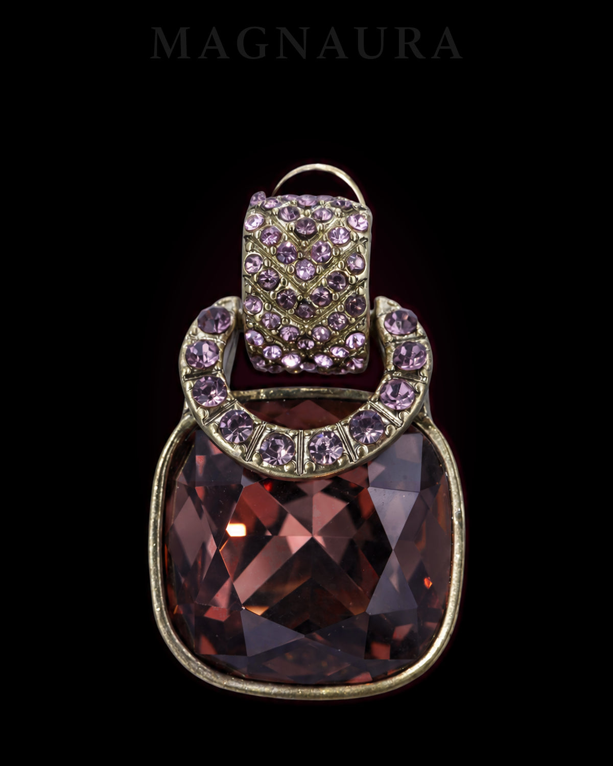 Close detail of a MAGNAURA Cognac Crescent earring with wine-brown faceted glass and purple crystal accents